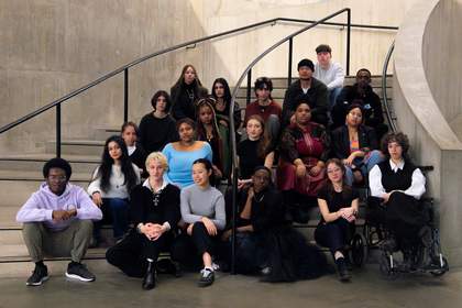 A mixed group of young people from the Tate Collective Producer group in London sitting on a staircase