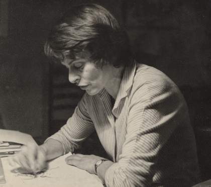 Black and white photograph of Milein Cosman sketching