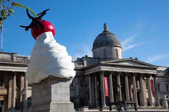 The fourth plinth in London's Trafalgar Square with a sculpture of ice cream and cherry with a drone on top