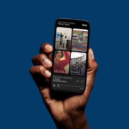 A hand holding a phone with an audio guide on the screen