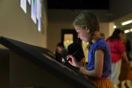 A child making a drawing on a digital sketchpad.