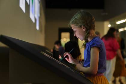 A child making a drawing on a digital sketchpad.