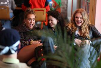 A photograph of a group of young people sat in Tate Liverpool's cafe during an event