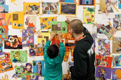 Man and boy in front of a large collage