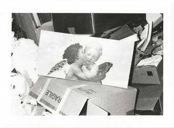 black and white image of cherubs on cardboard boxes