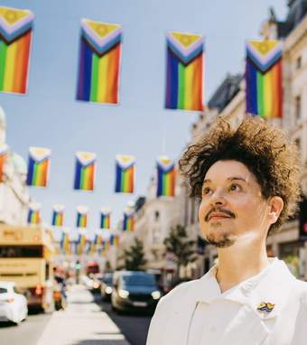 Valentino Vecchietti on a street with Intersex-Inclusive Pride flags