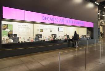 Ticket desk at Tate Modern with large purple sign