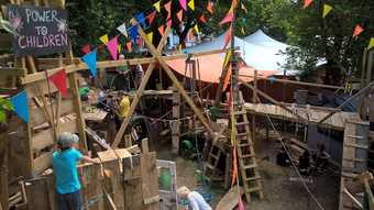 Children build with wood in a playground