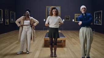 Image of three gallery visitors looking at a painting in Tate Britain