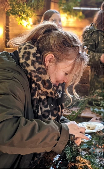 Photograph of a woman making a wreath