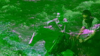 Two green-tinted images of a man riding a horse are overlaid on each other.