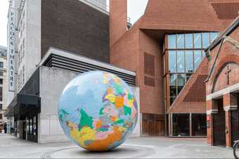 large monumental scale blow up globe installed in a courtyard