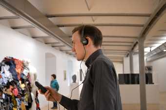 Visitor listening to Tate Liverpool's audio guide