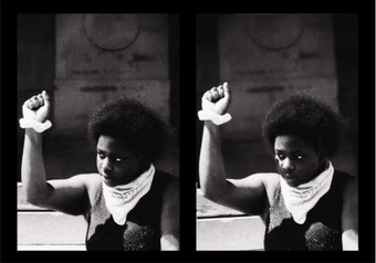  A Black person holds up a fist in triumph 