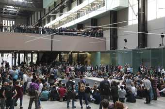 Crowd seen starting the gather to watch a dance performance in the Turbine Hall