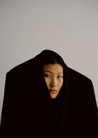 photo of a woman with her head poking out of a suit