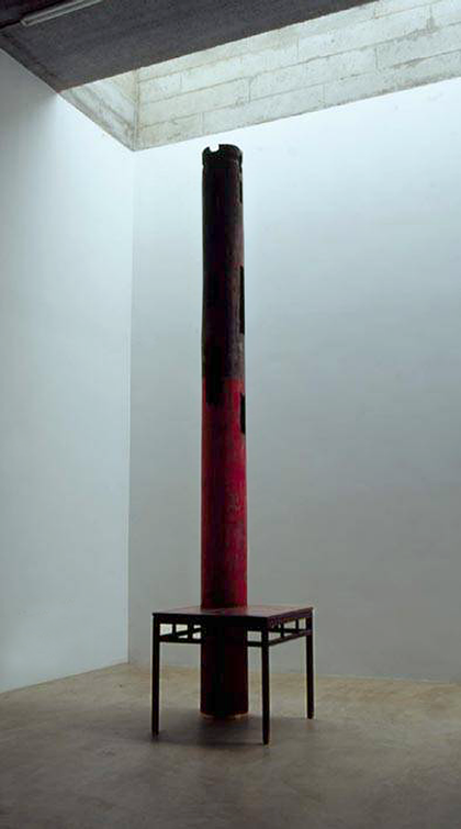 A metal pillar stands inside a metal table