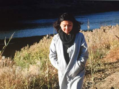 Photography of artist Tao Aimin walking in a rural landscape