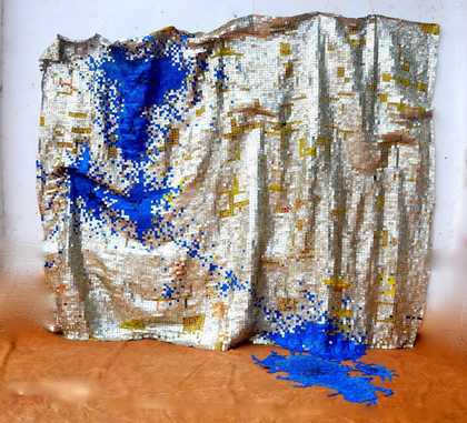Silver wall hanging with bright blue spots of colour