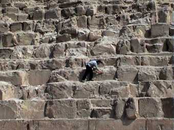 Andy Holden Return of the Pyramid Piece 2008 photograph of a man on the slope of an Egyptian pyrimad