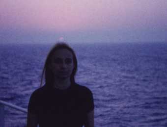 image of a woman by the sea in sunset