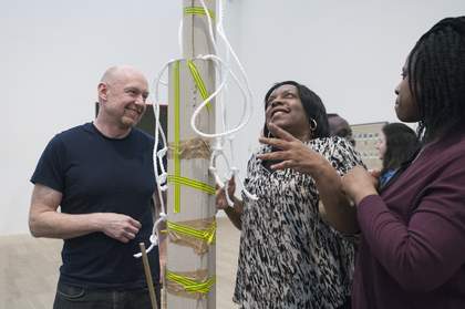 Two teachers looking at a sculpture