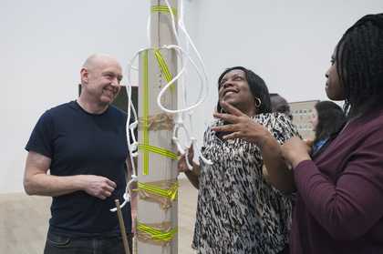 Two teachers looking at a sculpture