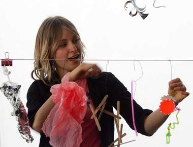 Girl making a mobile in response to music