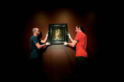 Art handlers hang Vermeer’s The Love Letter c.1669 at the National Gallery of Victoria, Melbourne