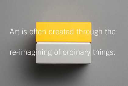 A yellow and grey coloured brick sit side by side with text on it