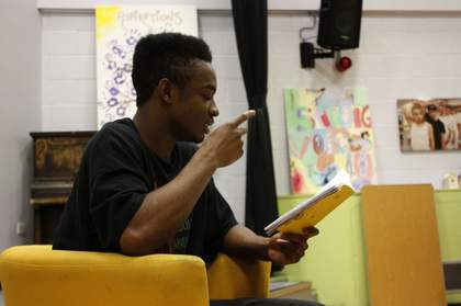 Photograph of a young writer reading his work