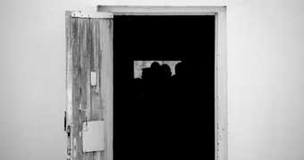 Black and white photograph of a door open