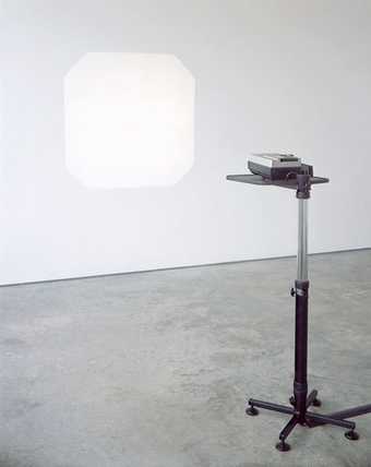 Ceal Floyer Auto Focus 2002 a photograph of a projector machine projecting a white square on to a white gallery wall