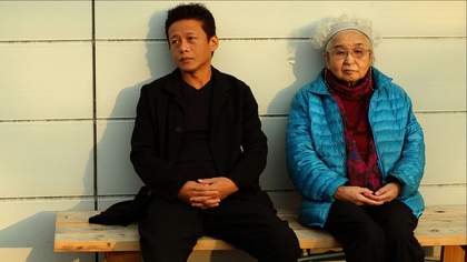 two people sit on a bench