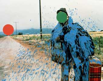 John Baldessari Hitch hiker Splattered Blue 1995 a photograph of a man at the side of a dirt road with a green dot covering the hitch hikers face added to the photo along with blue paint splatters