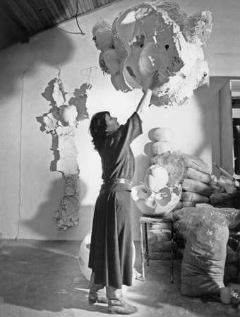 Maria Batuszová in her studio in Košice, Slovakia, with her sculptures evoking nests, hollowed eggs, shells and other natural forms, c1987