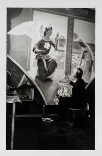 Photograph of Vanessa Bell painting 'The Annunciation' mural for Berwick Church, Tate Archive