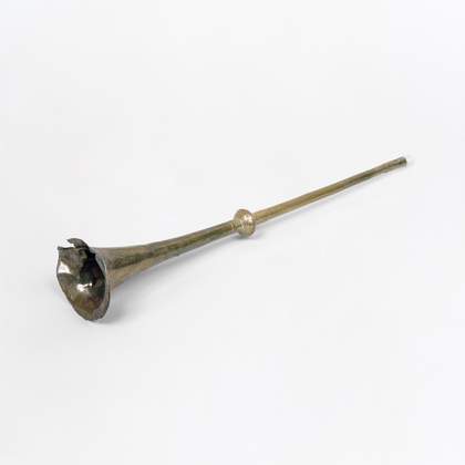 Photograph of silver damaged trumpet on a white background