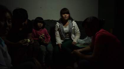 a woman sits on the sofa