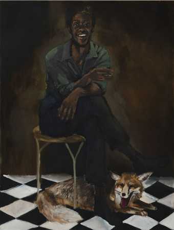 a man sits in a chair with a fox underneath on a tiled floor