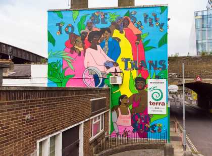 A bright mural reading to be safely trans outside, surrounded by Black trans and gender non-confirming folks