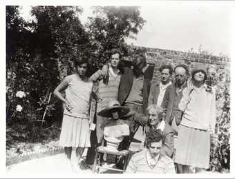 Photograph of family and friends of Vanessa Bell in the walled garden of her home, Charleston farmhouse, in Firle, Sussex