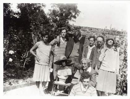 Photograph of family and friends of Vanessa Bell in the walled garden of her home, Charleston farmhouse, in Firle, Sussex
