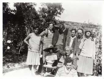 Photograph of family and friends of Vanessa Bell in the walled garden of her home, Charleston farmhouse, in Firle, Sussex. © Tate