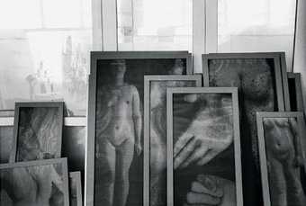 Christian Boltanski, many works against window in studio