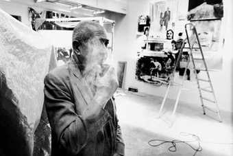 Christian Boltanski smoking in studio