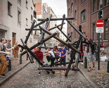 children stand underneath a hexagon style structure