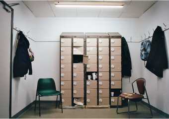  A set of lockers, some of which are open and spilling paper 