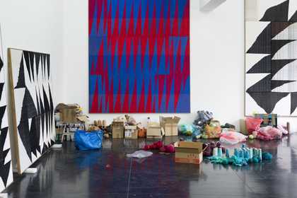 A workshop space with lots of different threads and weavings