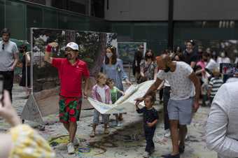 Ei Arakawa leads a family activity in the Turbine Hall at Tate Modern during Mega Please Draw Freely